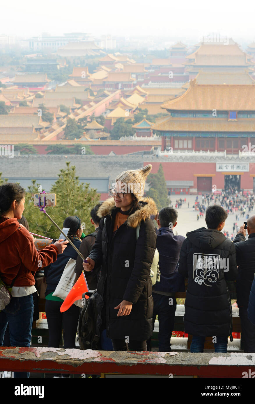 Una donna prende un selfie nel padiglione principale nel Parco Jingshan a Pechino in Cina, con la Città Proibita dietro Foto Stock Una donna prende un selfie nel padiglione principale nel Parco Jingshan a Pechino in Cina, con la Città Proibita dietro Foto Stock