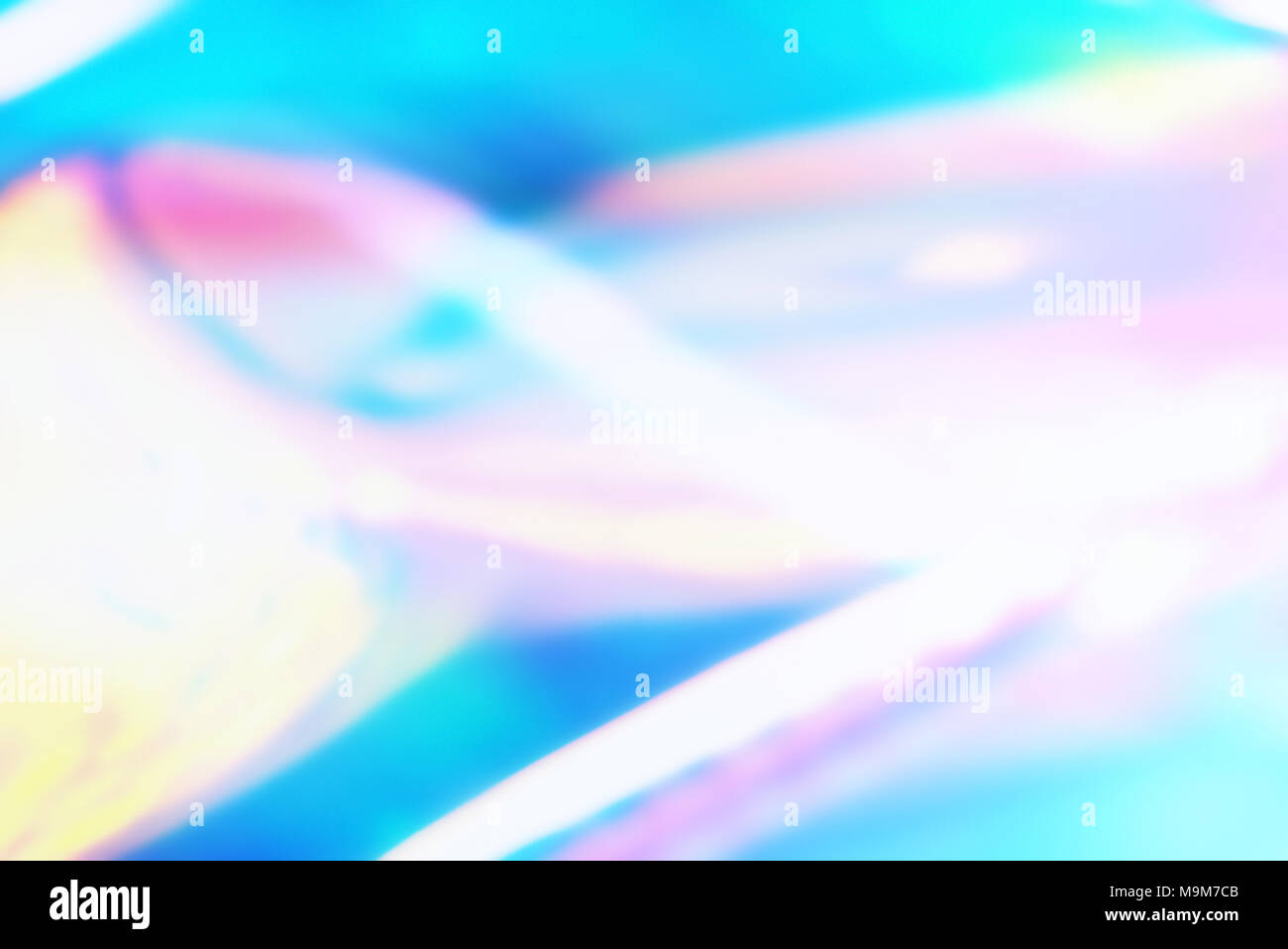 Colorato luminoso sfondo olografico con le onde della luce. La vibrante foil olografico sfondo. Foto Stock