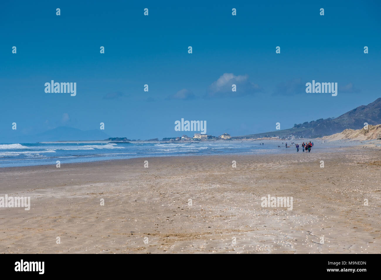 Walkers voce lungo la spiaggia verso Tywyn, Gwynedd, Galles Foto Stock