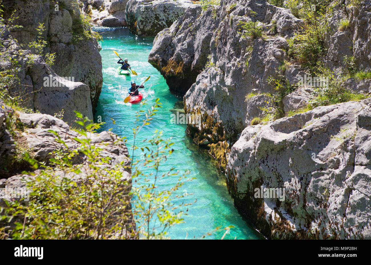 Kayakkers sul Smeraldo Soca vicino a Bovec in Slovenia. Questa colorata verde fiume originari delle montagne del Triglav è famosa per tutti i tipi di acque bianche attività. Foto Stock