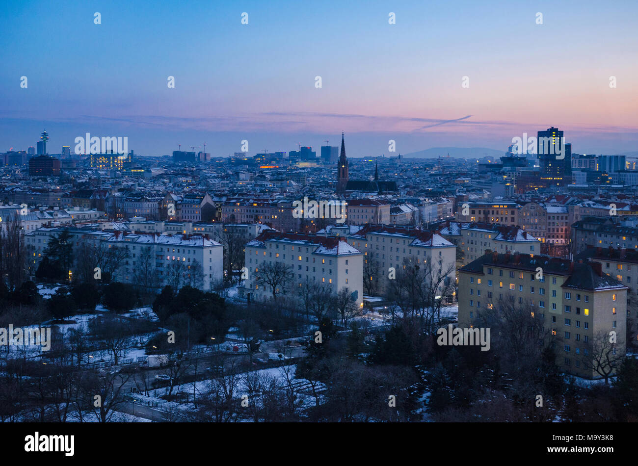 Una sera d'inverno imposta su Vienna come il sole tramonta e le molte finestre della città iniziano ad accendersi Foto Stock