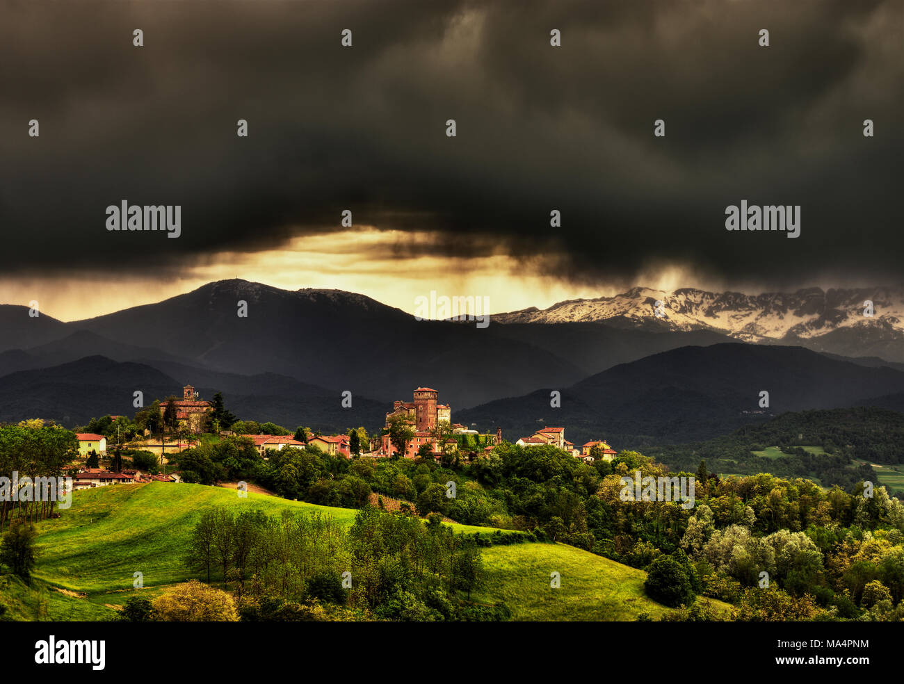 Il villaggio di Ciglié con il suo castello medievale, nelle Langhe in Piemonte, Italty. Sullo sfondo le Alpi Marittime e il monte Mindino. Foto Stock