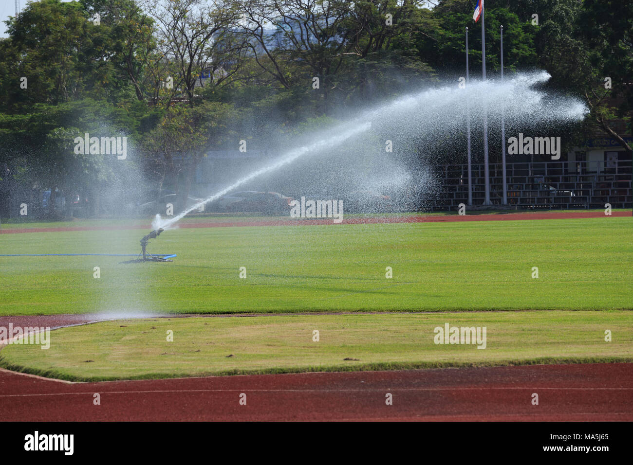 Gli sprinkler spruzzatura di acqua su erba nel campo di calcio Foto Stock
