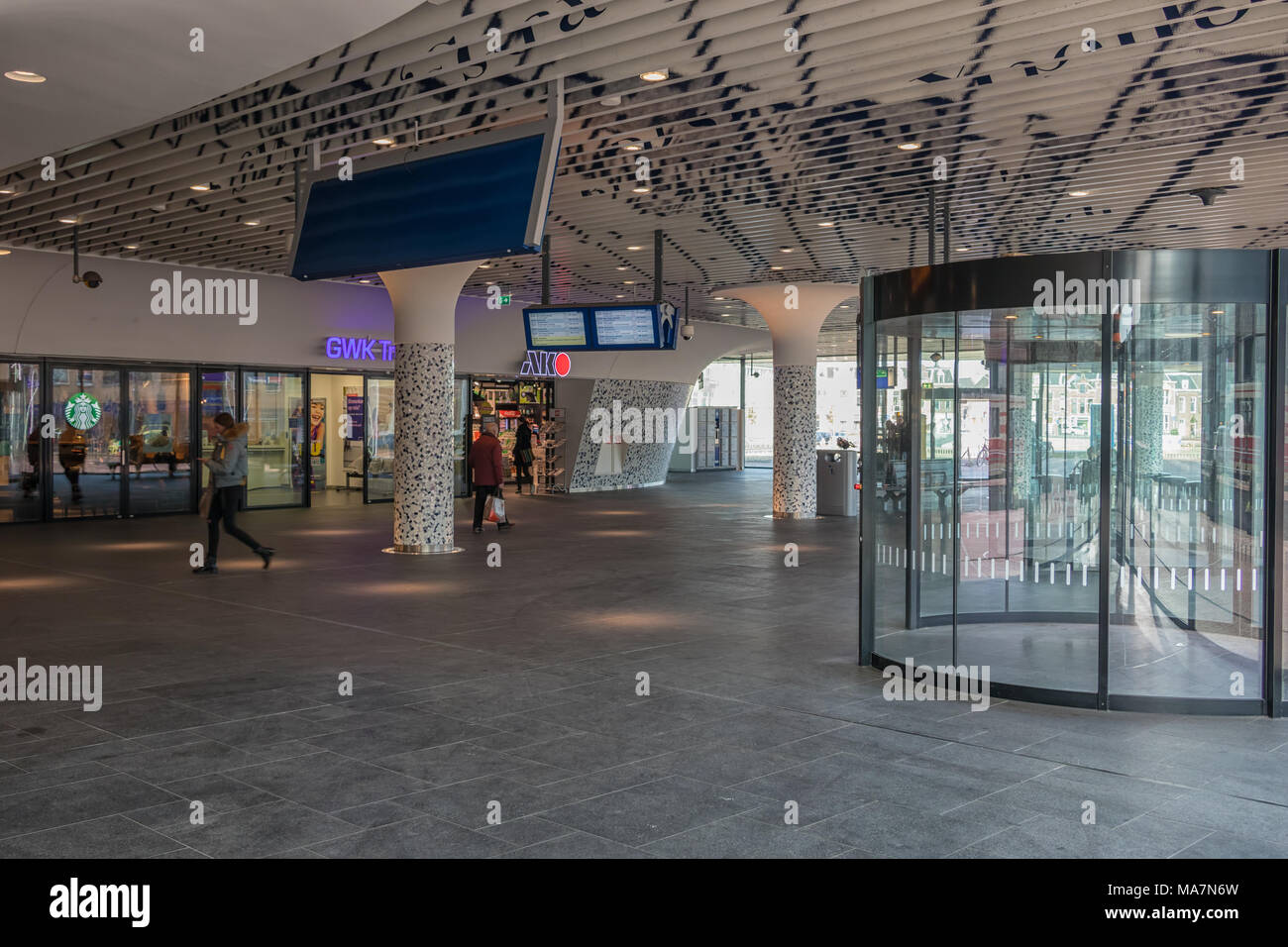 Viaggiatori nell atrio della stazione ferroviaria di Delft con arte moderna soffitto Foto Stock