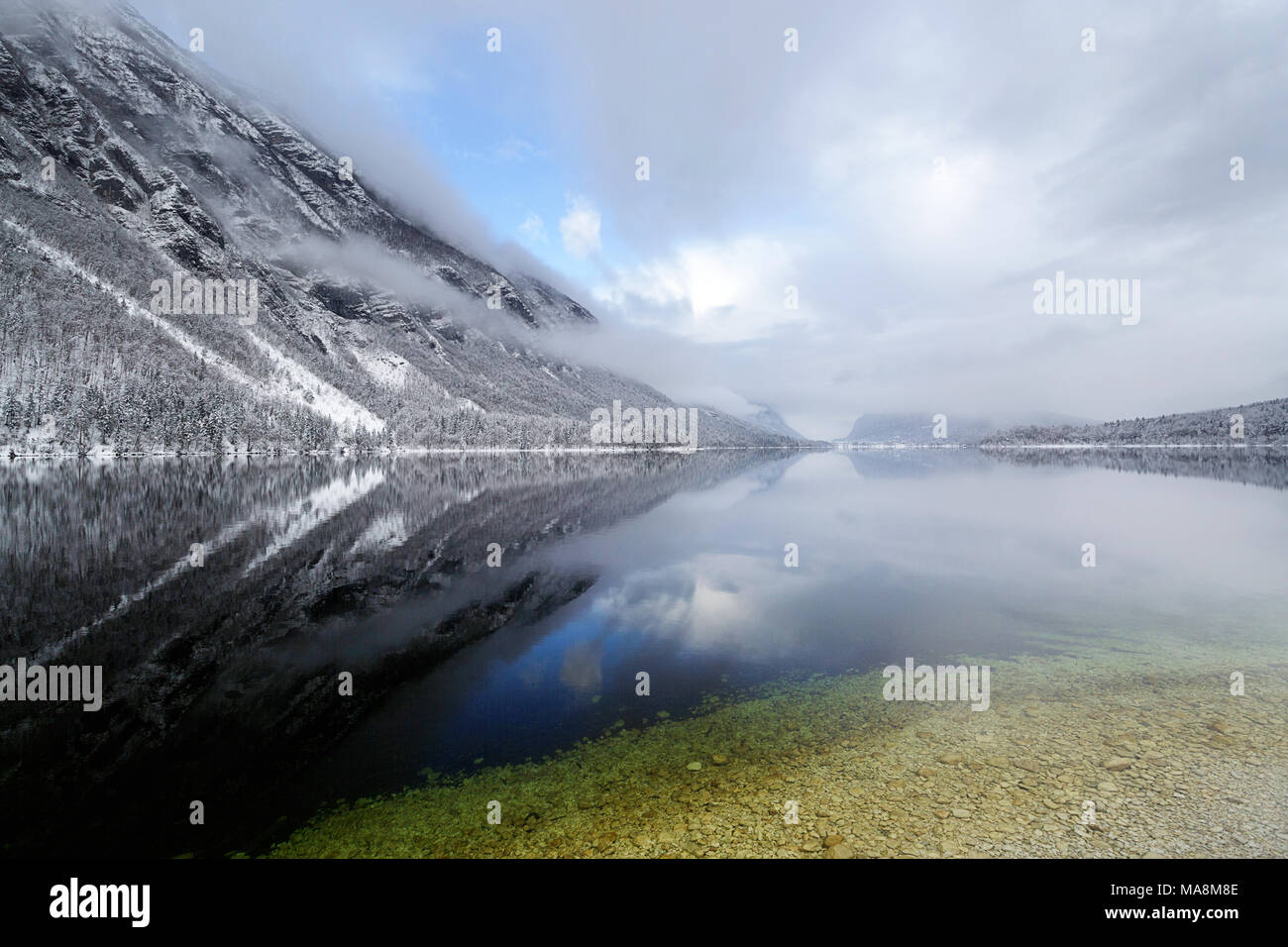 Il lago di Bohinj in condizioni di neve in una fredda giornata invernale Foto Stock