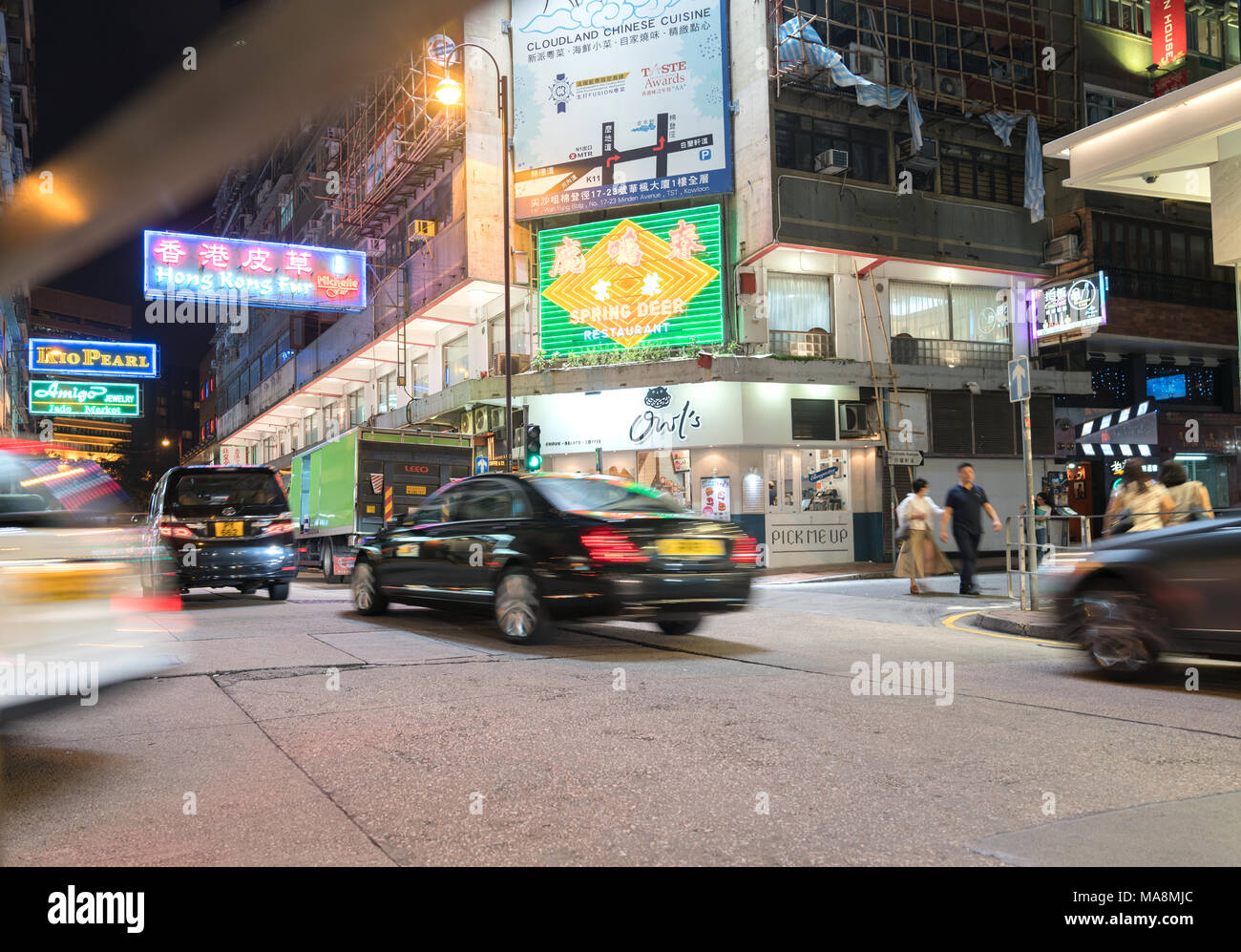 KOWLOON, HONG KONG - 18 settembre 2017; luminose insegne al neon dominano in esposizione lunga scena notturna tipicamente Asian downtown city corner street pe sfocata Foto Stock