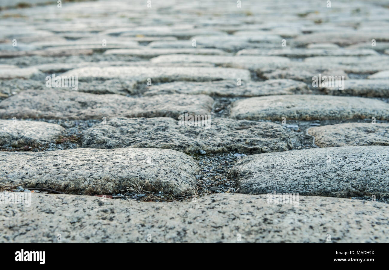 Close Up di ciottoli Stone Street da angolo basso Foto Stock