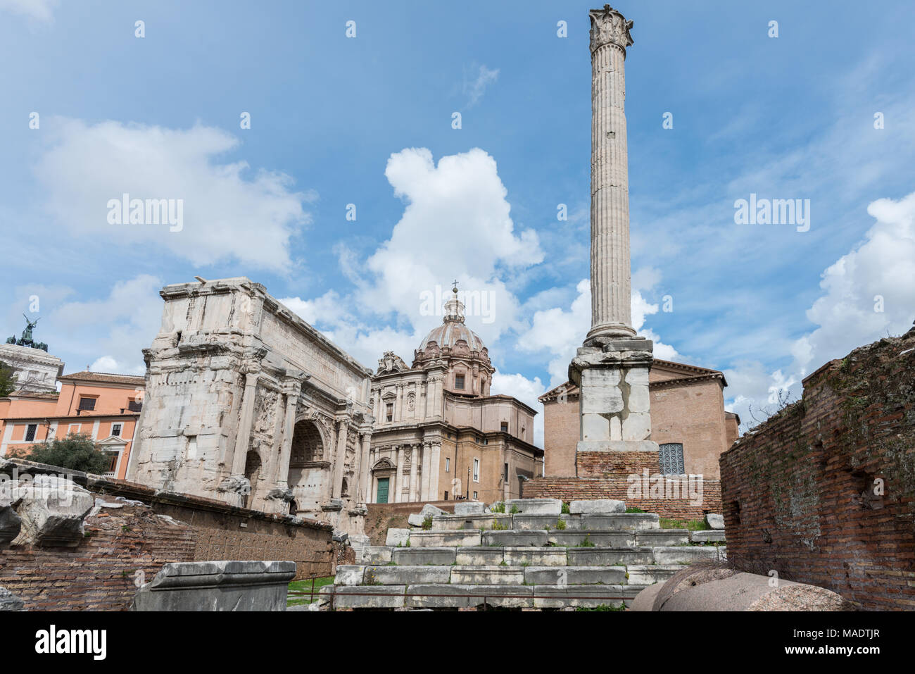 Ampio angolo di immagine dell'Arco di Tito e un vecchio pilar dall' antico edificio dall Impero Romano in Roma, Italia Foto Stock