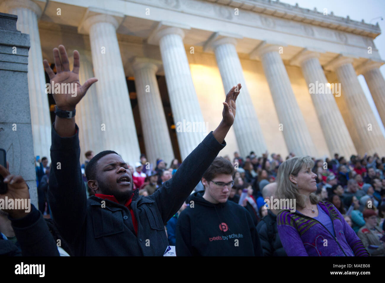 Washington, DC, Stati Uniti d'America. Il 1 aprile, 2018. Umile Peters, dalla Nigeria, unisce le migliaia di persone che prendono parte al quarantesimo Pasqua annuale servizi Sunrise sui gradini del Lincoln Memorial. Questo evento è cominciato nel 1979 con un piccolo gruppo di persone ed è cresciuto fino a diventare uno dei più grandi di Pasqua preghiera sunrise servizi negli Stati Uniti, che richiama gente da Washington, DC area così come da tutto il mondo. Asta Lamkey Jr./Alamy Live News Foto Stock