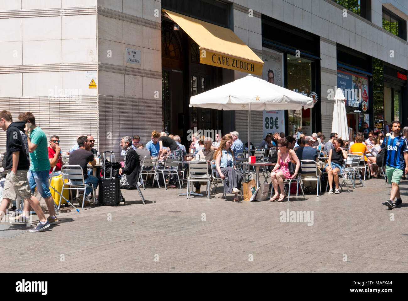 La gente seduta al di fuori di un cafe a La Rambla, Barcelona, Spagna Foto Stock