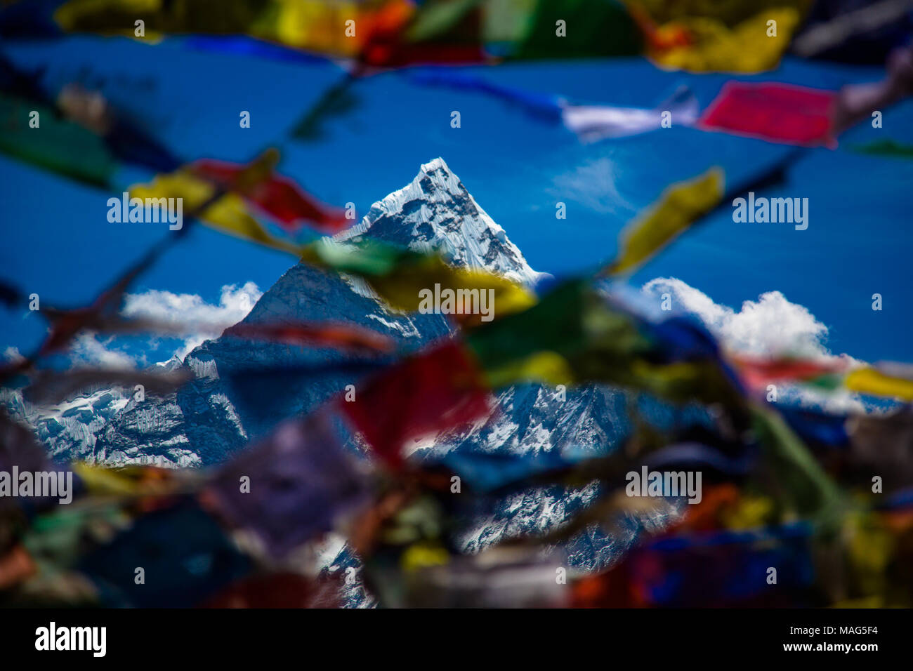 Pokhara di montagna come visto attraverso un colorato spray di preghiera nepalesi bandiere al vento. Himalaya, Nepal Foto Stock