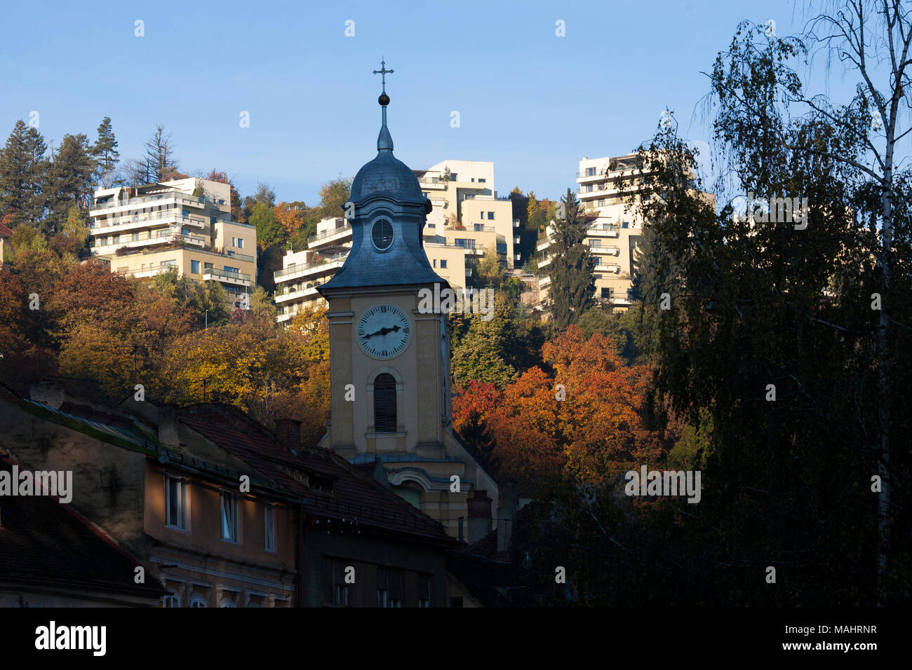 I colori autunnali silhouette gli alberi nel centro di Brasov, Romania. Foto Stock