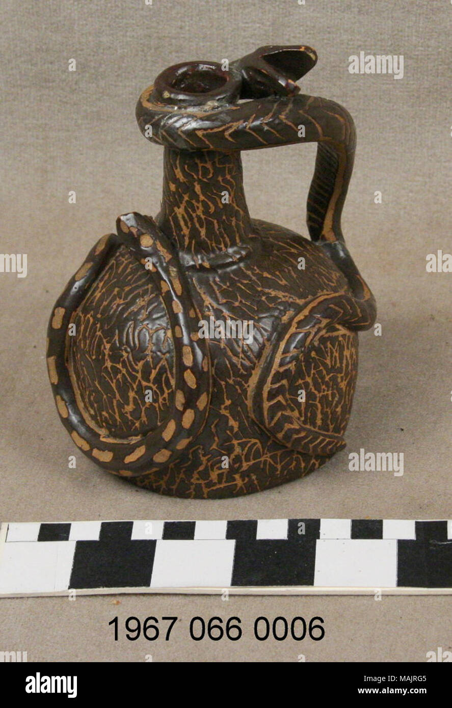 Marrone e tan-serpente gestite brocca in gres. Albany slip smalto con incisi disegni lineari. Corpo globulare. I serpenti con freccette, bilancia e macchie. Titolo: Marrone Caraffa in ceramica con manico di serpente . tra 1867 e 1890. J.M. Jegglin Foto Stock