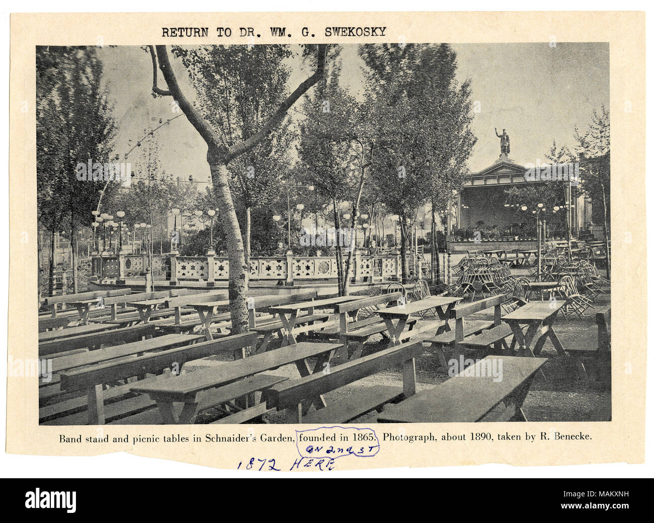 In orizzontale e di fotografia in bianco e nero da un libro della Schnaider's Beer Garden. La fotografia è dotato di due file di tavoli da picnic e tavoli con sedie. Una fase è presente in background con una statua centrato sulla parte superiore del tetto. Al centro del giardino offre un decorativo circolare staccionata in legno con lampade in cui due ragazze magra contro il recinto interno. Titolo: Schnaider's Beer Garden. 1100 Blocco del Mississippi. . Nel 1890 circa. Swekosky, William G., 1895-1964 Foto Stock In orizzontale e di fotografia in bianco e nero da un libro della Schnaider's Beer Garden. La fotografia è dotato di due file di tavoli da picnic e tavoli con sedie. Una fase è presente in background con una statua centrato sulla parte superiore del tetto. Al centro del giardino offre un decorativo circolare staccionata in legno con lampade in cui due ragazze magra contro il recinto interno. Titolo: Schnaider's Beer Garden. 1100 Blocco del Mississippi. . Nel 1890 circa. Swekosky, William G., 1895-1964 Foto Stock