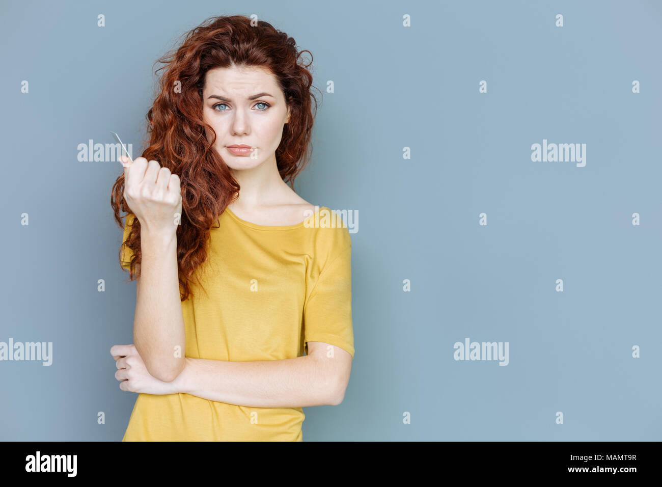 Piacevole dai capelli rossi donna guardando a voi Foto Stock