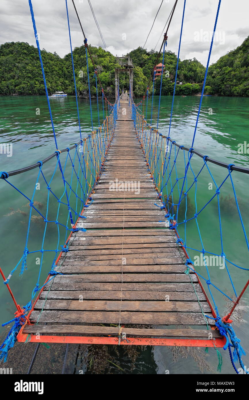 Cavalletto e sospensione passerella doppia di bambù e tavole di legno con rete ringhiere e bandiere di collegamento e Latasan Tinagong Dagat isole. Sipal Foto Stock
