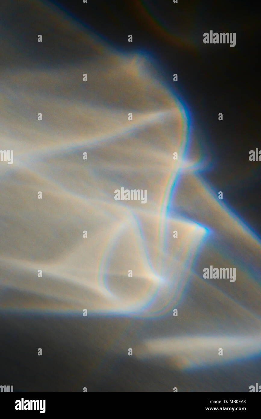 La luce solare attraverso la finestra si illumina la parete con suggestivi modelli onirico e colori creazione astratta di sfondo Foto Stock