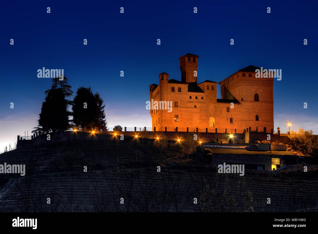 Il Premio Grinzane Cavour Castello (Patrimonio Mondiale dell'Unesco), sede dell'Alba tartufo bianco mondo d'asta, illuminato al calar della sera. Foto Stock