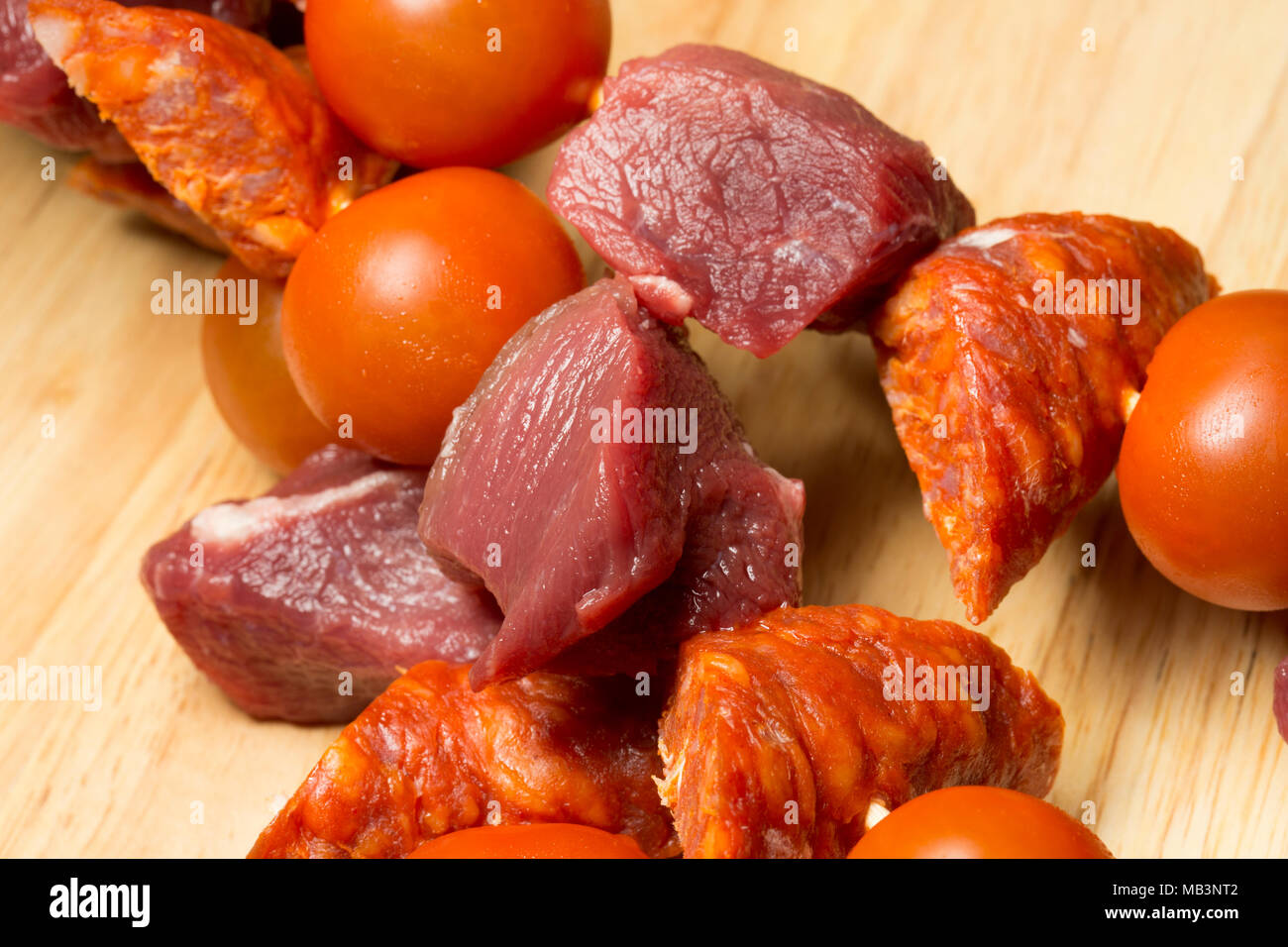 A cubetti, materie di cinghiale, il salame chorizo e pomodori ciliegia  attorno alla griglia. La carne