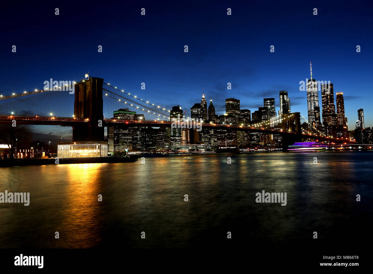 La spettacolare skyline di New York City, Stati Uniti d'America da twilight tra cui il celeberrimo Ponte di Brooklyn. Foto Stock