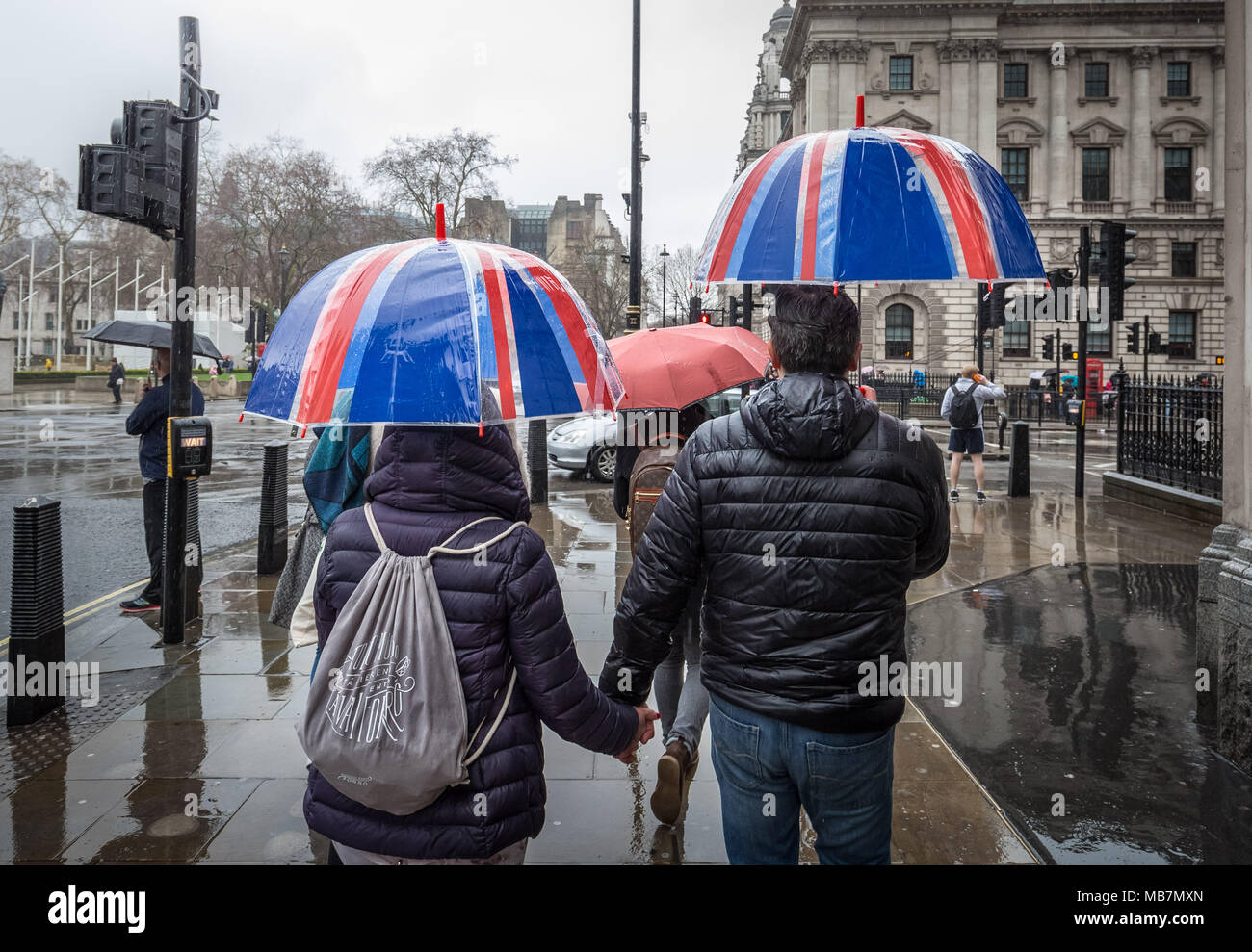 Londra, Regno Unito. 8 Aprile, 2018. Meteo REGNO UNITO: Unione bandiera ombrelloni su un umido e piovosa domenica pomeriggio a Westminster. Credito: Guy Corbishley/Alamy Live News Foto Stock