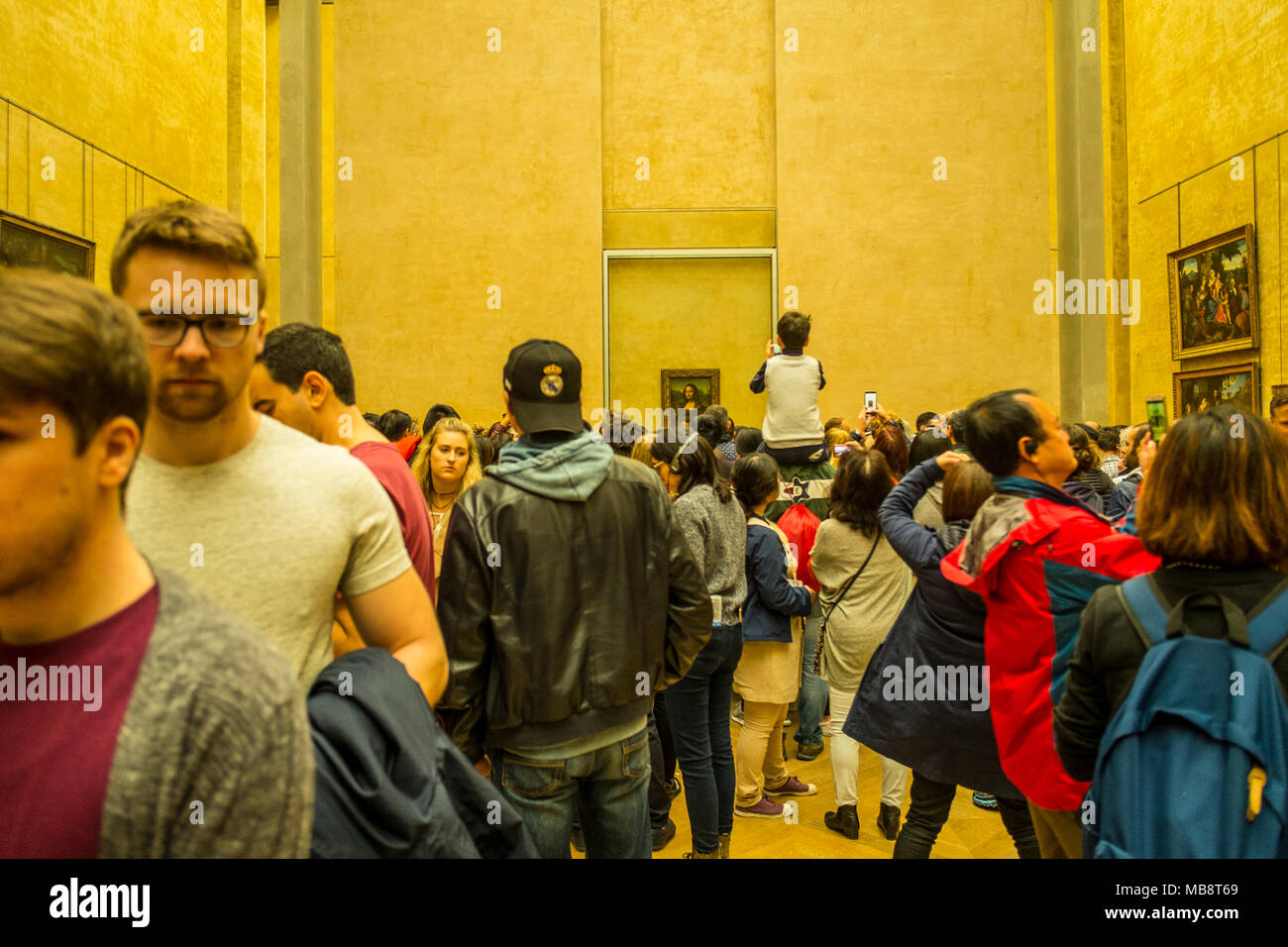 I turisti cercando di ottenere un assaggio di Leonardo la Mona Lisa di Leonardo da Vinci presso il Museo del Louvre, Francia Foto Stock