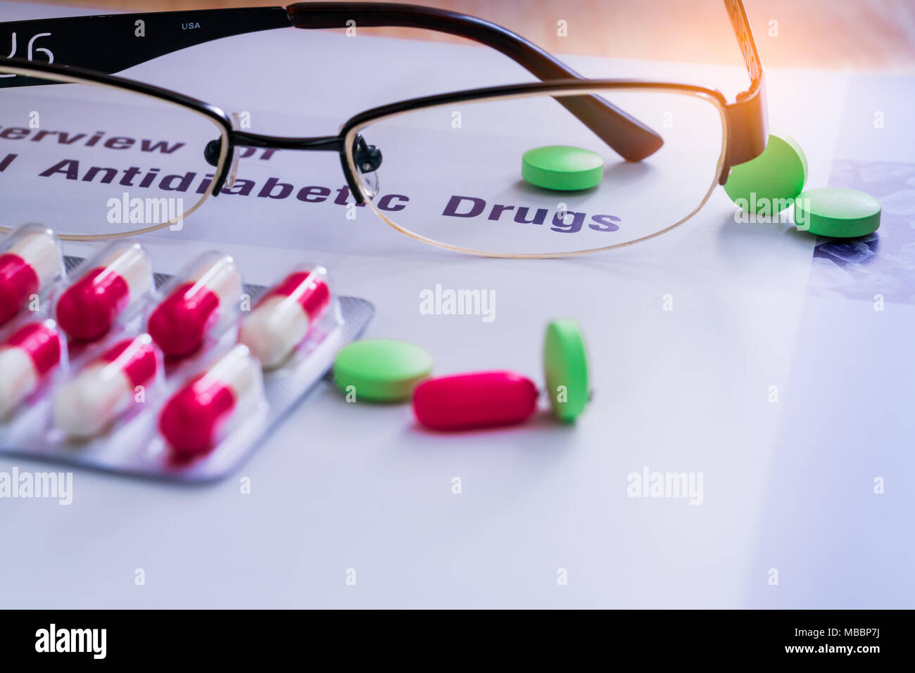 Farmaci diabete e bicchieri collocato su di un libro di testo. Il diabete mellito di tipo 2 concetto. Foto Stock
