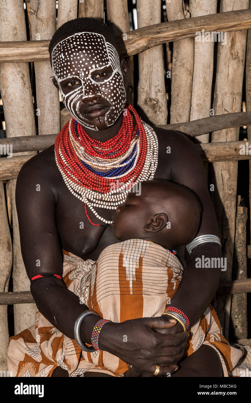 Giovane donna con la faccia dipinta e baby, Karo tribù, sud della nazionalità delle nazioni e dei popoli " Regione, Etiopia Foto Stock