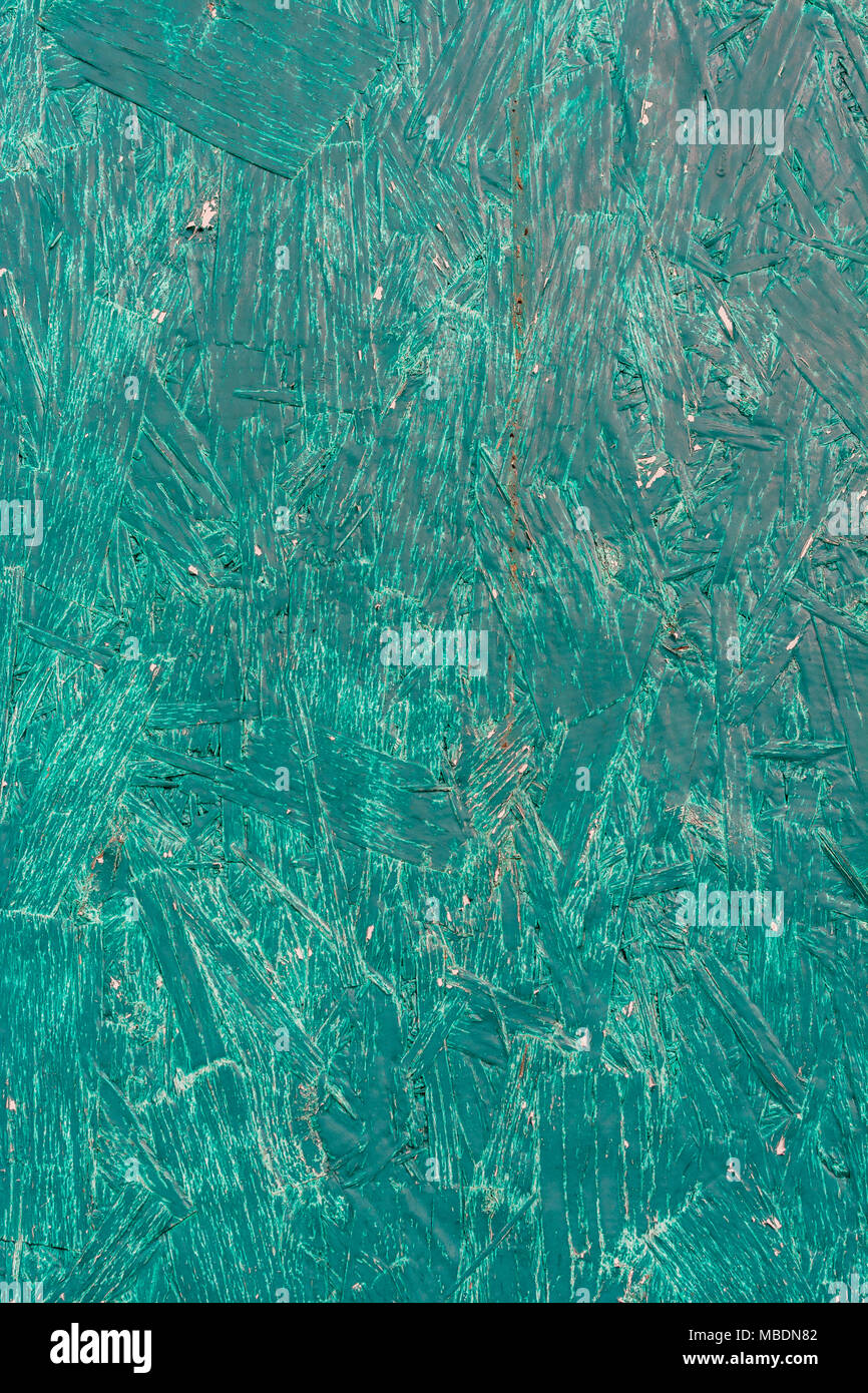 Close-up di pennellate di un pezzo di verde Compensato verniciato, mostrando la vernice texture. La vecchia vernice texture. Foto Stock