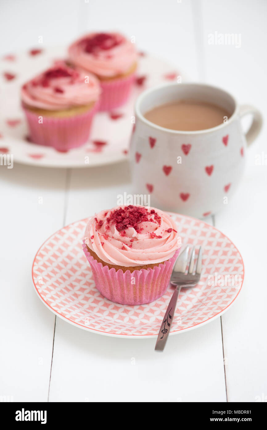 Lampone tortine su una piastra con una tazza di tè Foto Stock