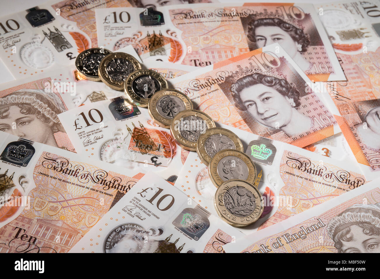 Nuovo stile di £ 1 monete sulla parte superiore del Regno Unito £ 10,00 note Foto Stock