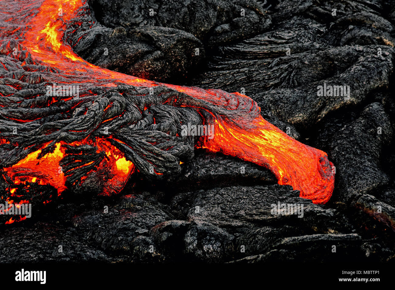 Magma calda fuoriesce da una colonna di massa come parte di un flusso di lava attivo, la lava incandescente si raffredda lentamente e si blocca - Ubicazione: Hawaii, Big Island, volca Foto Stock