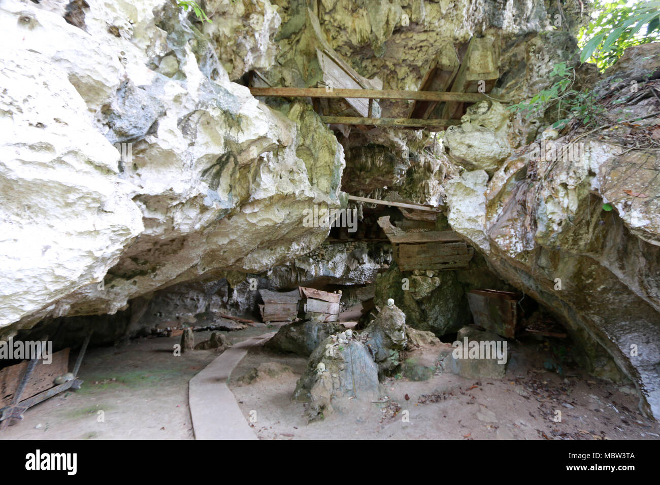 Il marcio bare, custodi dei morti (Tau-Tau's) e teschi umani in Tampang Allo grotta sepolcrale, Sulawesi, Indonesia Foto Stock