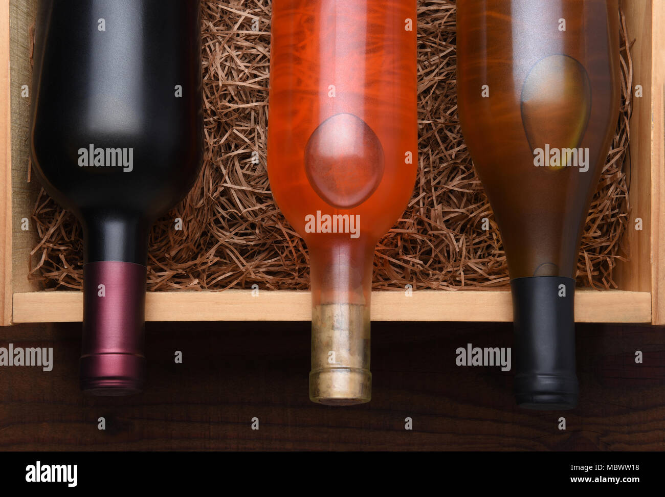 Tre bottiglie di vino: Bottiglie di Cabernet, Blush e Chardonnay vino in una scatola di legno con imballaggio paglia. Foto Stock