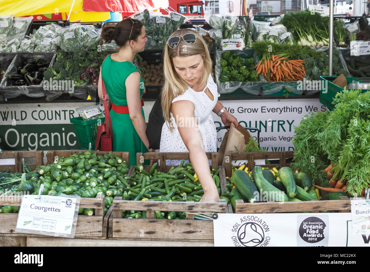 Mercato agricolo di Marylebone, clienti che acquistano ortaggi biologici. Mercato alimentare britannico. Prodotti britannici. Foto Stock