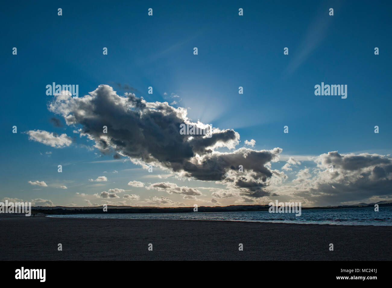 Seascape con la spiaggia e il mare in background con un luminoso cielo blu con soffici nuvole Foto Stock