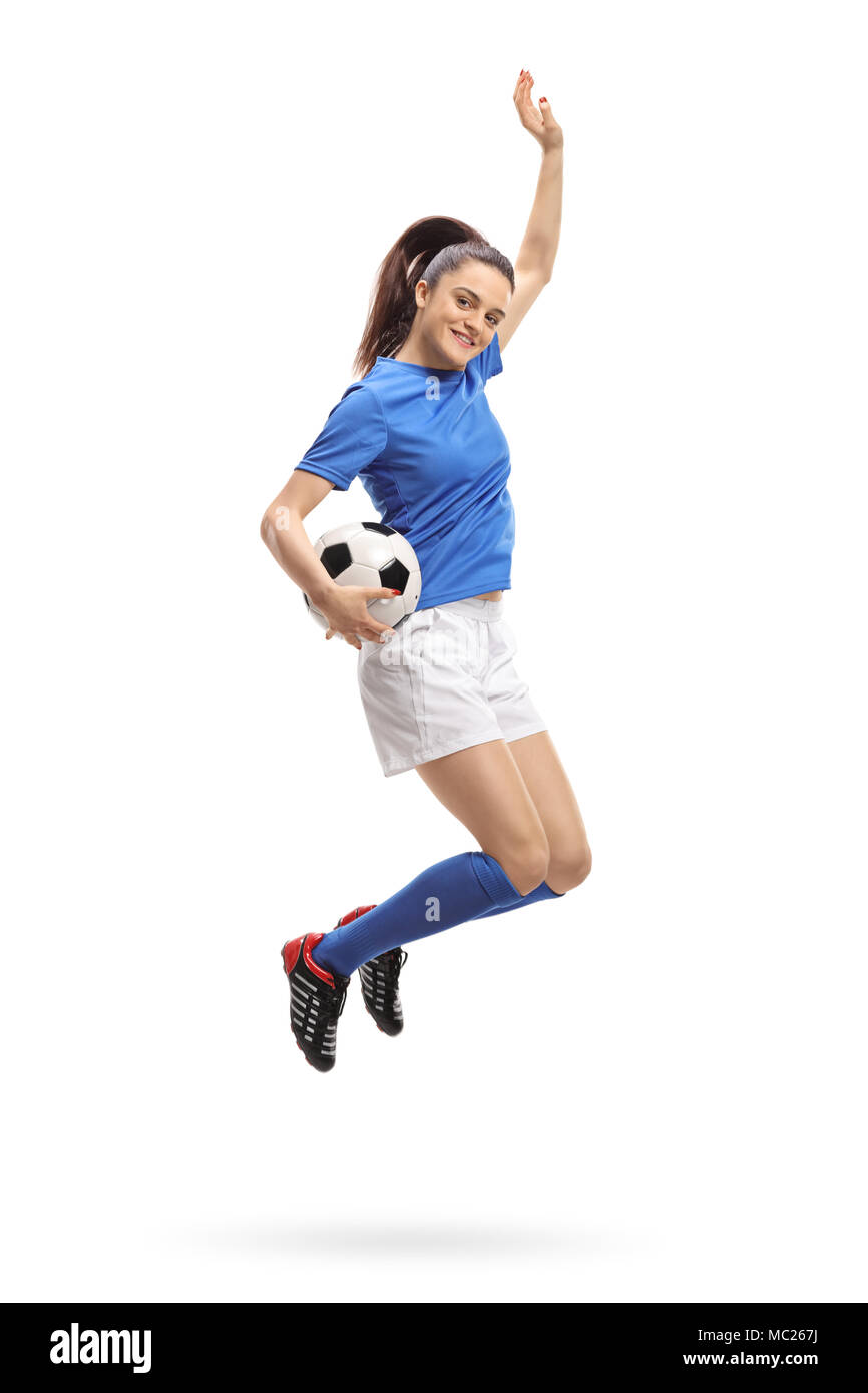 A piena lunghezza verticale di una femmina di giocatore di calcio del salto e gesticolando felicità isolati su sfondo bianco Foto Stock