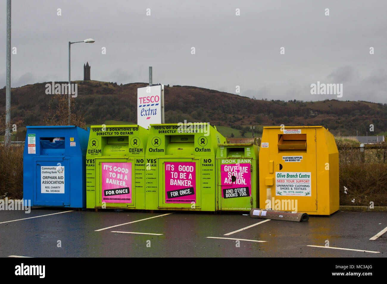 Acciaio colorato abbigliamento banche per beneficenza situato nel locale di Tesco Extra Parcheggio auto a Derry contea di Down Irlanda del Nord Foto Stock