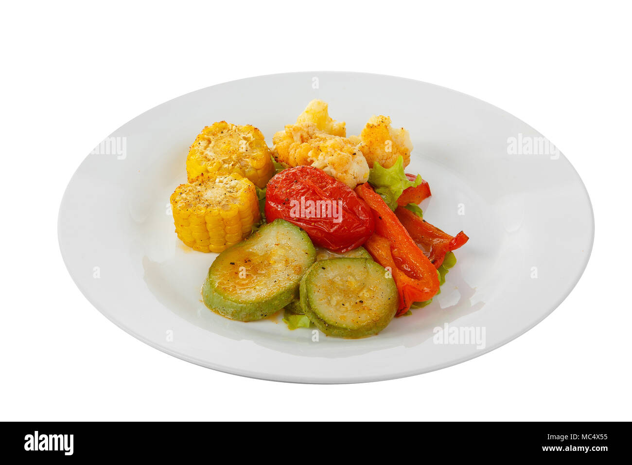 Verdure grigliate di tratto di contorno su una piastra bianca su sfondo isolato in vista laterale. Appetitoso piatto per il menu ristorante, bar, cafe Foto Stock
