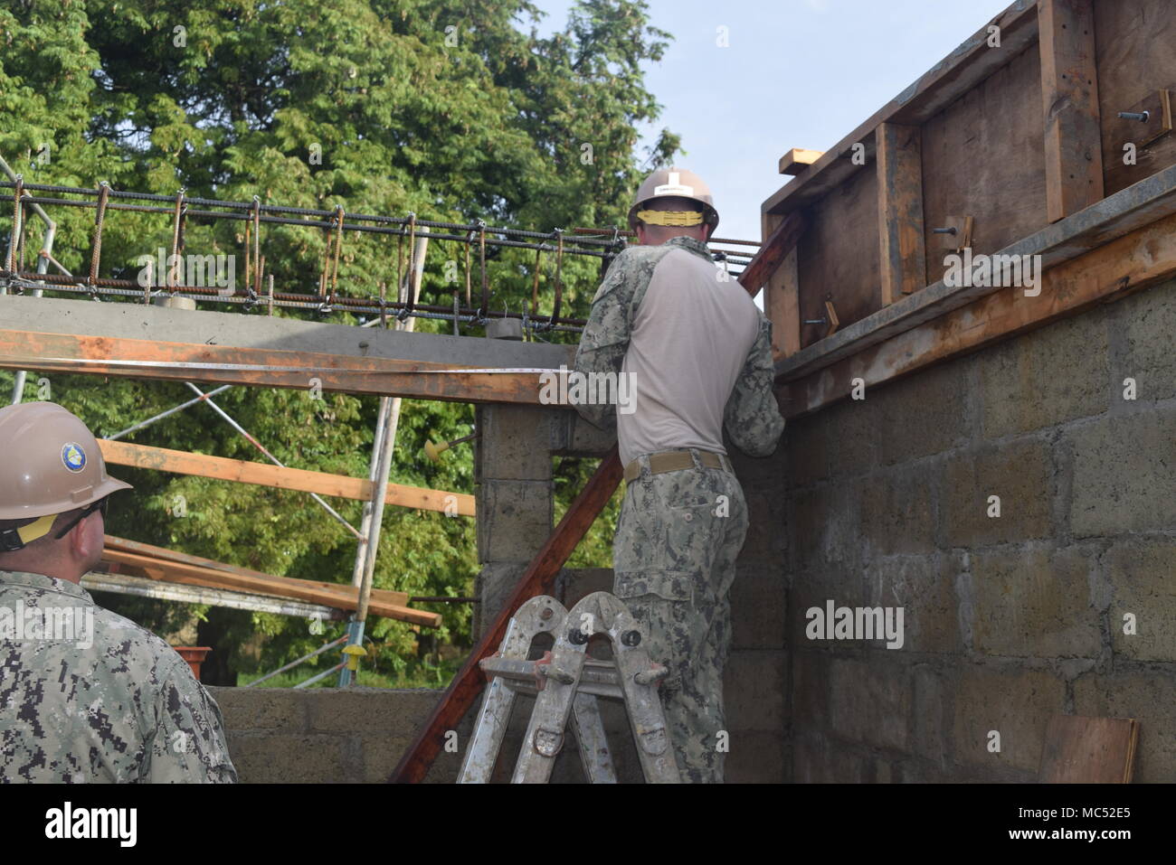 171018-N-N181-0213, PALAWAN FILIPPINE (17 gennaio 2018) Costruzione elettricista 2a classe Silvestro Chieng assegnato alla Naval Mobile Battaglione di costruzione (NMCB) 4, pale ghiaia dove il marciapiede cassaforma sarà collocato intorno la latrina. Il completamento del progetto di costruzione andrà a beneficio delle forze armate delle Filippine e gli Stati Uniti le forze mentre conducendo esercizi di formazione nella zona di operazioni. (U.S. Navy foto di costruzione elettricista Constructionman Ashley Concepcion/rilasciato) Foto Stock