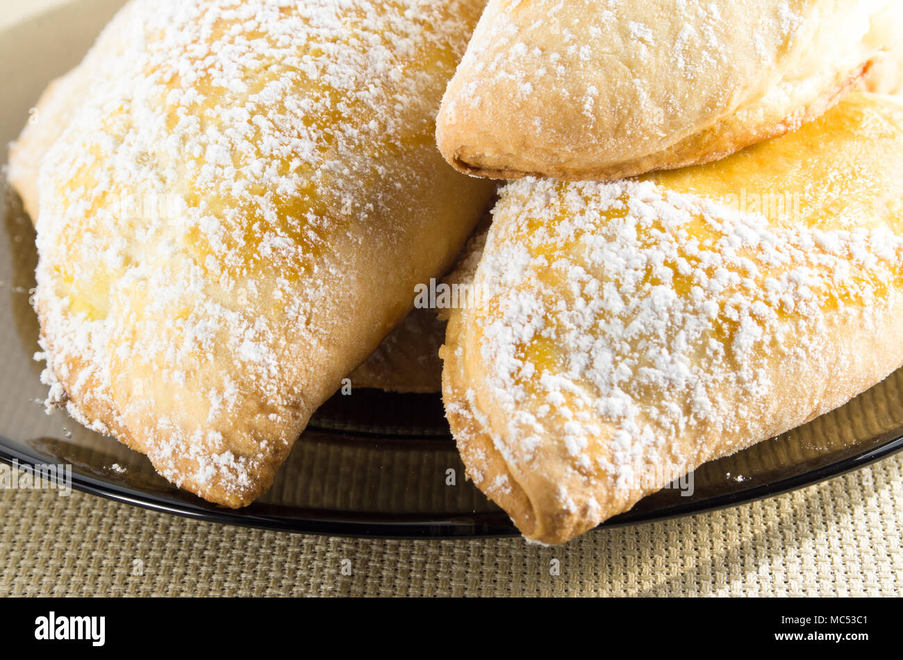 Torte calde con ripieno dolce, spolverati con zucchero a velo closeup Foto Stock