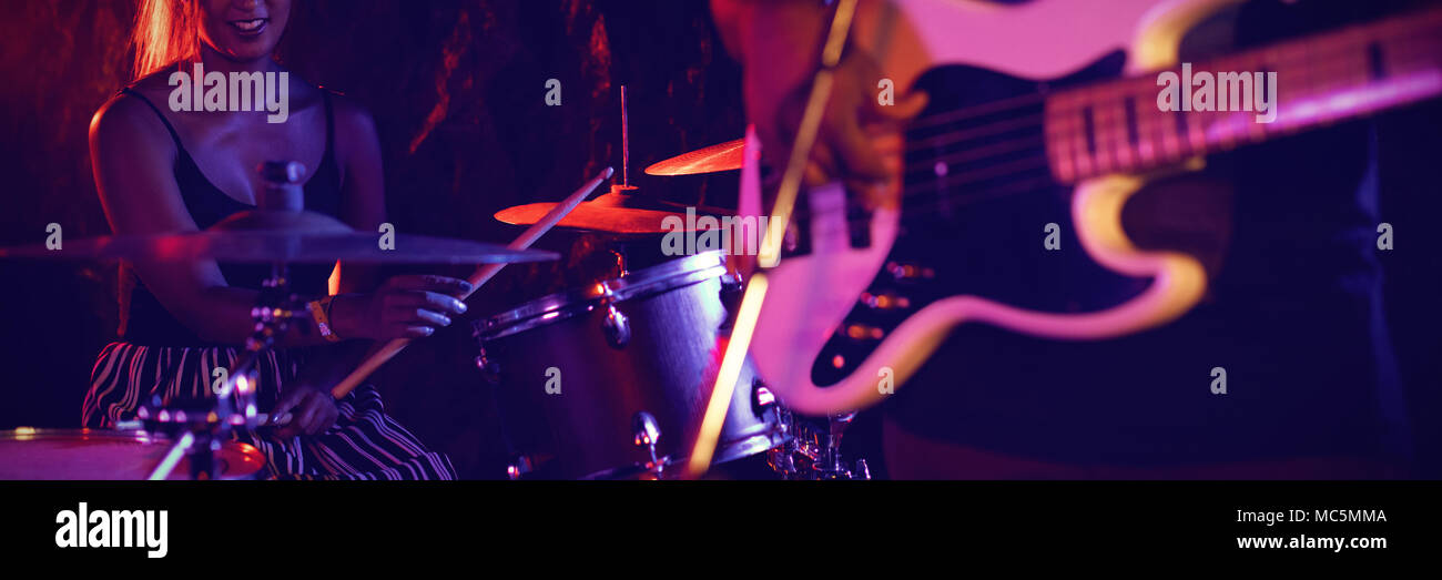 Uomo a suonare la chitarra con il batterista femmina in discoteca Foto Stock