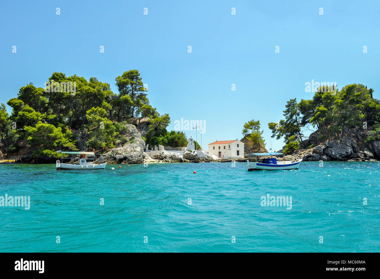 Parga, Epiro - Grecia. Avvicinando la isola di Panagia vicino al porto di Parga. Giornata soleggiata con cielo blu chiaro Foto Stock