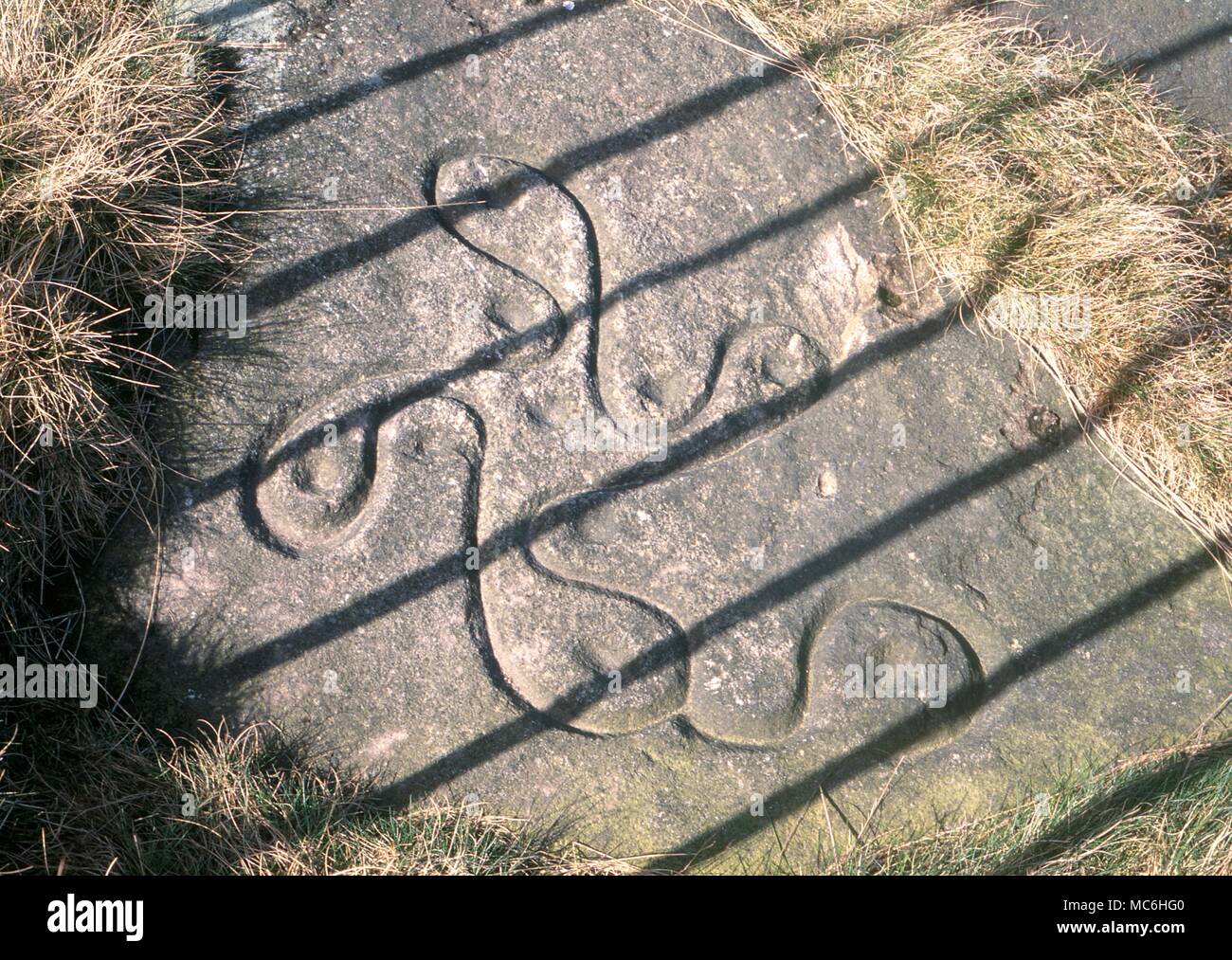 Ley linee. Simboli sulla preistoria svastica sopra pietra Ilkley Moor, Yorkshire. Datato a 2.000 BC. È incisa sulla superficie superiore di una parete di roccia, questa immagine guarda verso Addingham. La pietra è un importante nexus in un sistema di leys. Foto Stock