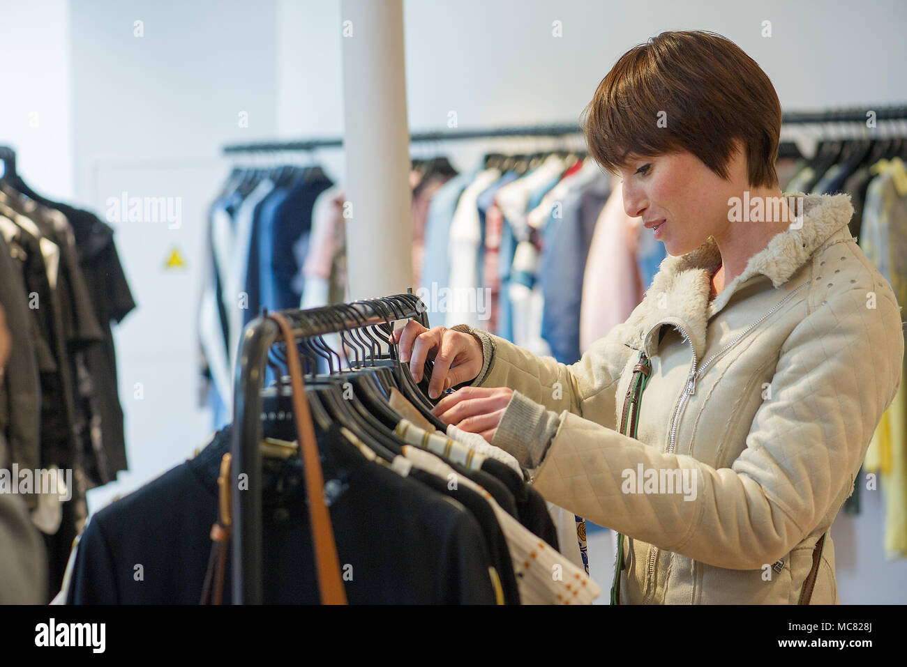 Donna shopping nel negozio di abbigliamento Foto Stock