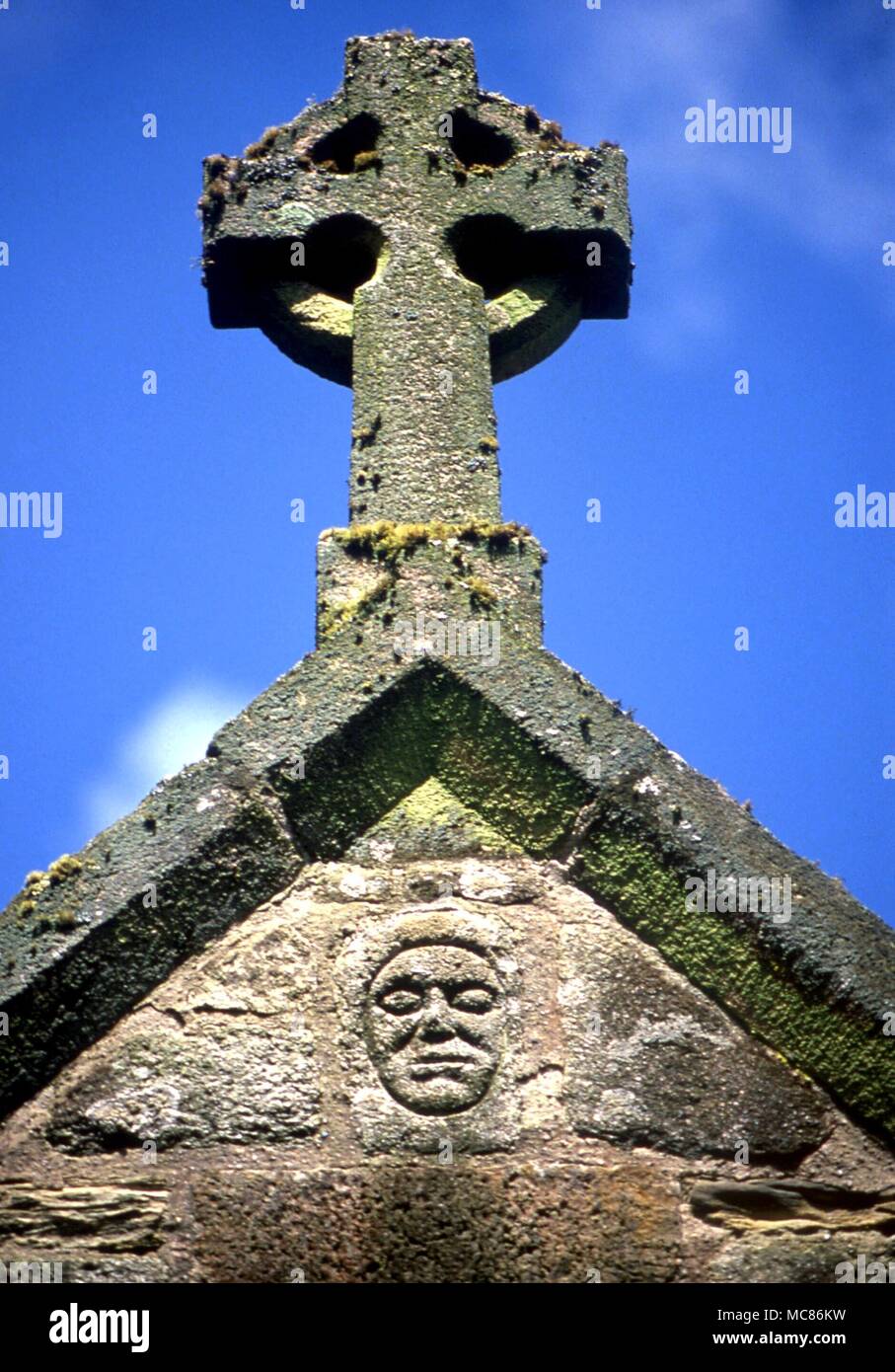 Testa celtica Celtic testa o testata amuletic, forse di origine la testa di un santo, impostata sopra il portico della chiesa parrocchiale di Perranzuloe, Cornwall Foto Stock