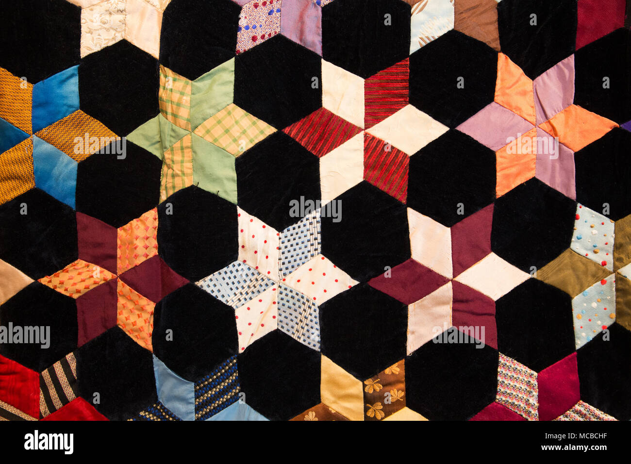Le forme geometriche e i dettagli sul tessuto colorato coperta di quilt Foto Stock