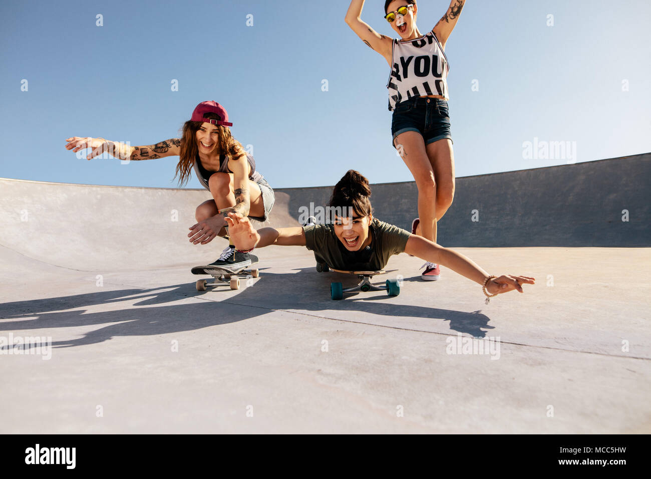 Un gruppo di ragazze in sella di skateboard e divertirsi a skate park.  Felici donne amici godendo lo skateboard all'esterno Foto stock - Alamy