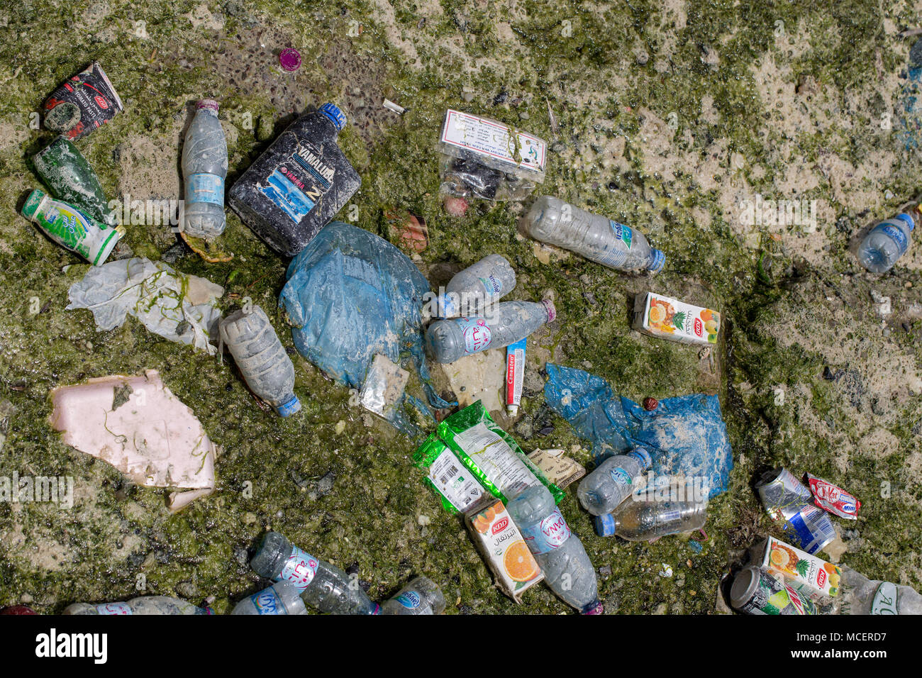 La baia di Doha, Qatar - 16 Aprile 2018: i detriti lasciati dietro nella baia di Doha, Qatar, dalla marea in uscita - una miscela di materia plastica, metallo e carta Foto Stock