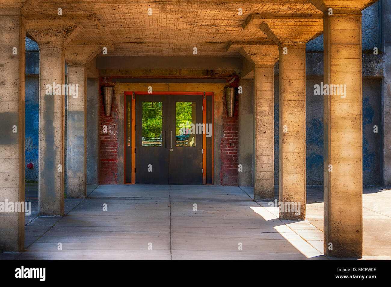 Un ingresso di un vecchio edificio. Il bagliore del sole del pomeriggio dà vita al apparentemente deserta edificio. Foto Stock